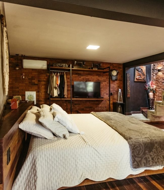 A bedroom with a bed and a television in it